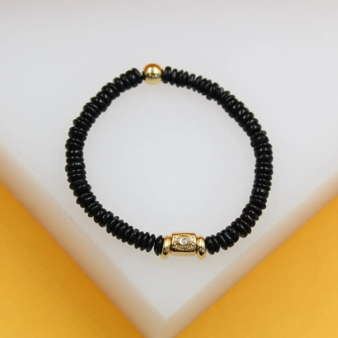 gold evil eye bracelet with black discs